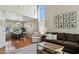 Open-concept living and dining area with hardwood floors, large windows, and stylish decor at 9264 E Hillery Way, Scottsdale, AZ 85260