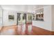 Bright living room flowing into the kitchen with hardwood floors and a patio entrance at 9264 E Hillery Way, Scottsdale, AZ 85260