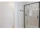 Bathroom featuring a modern glass enclosed shower with contrasting fixtures and marble patterned shower at 9264 E Hillery Way, Scottsdale, AZ 85260