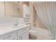 Bathroom with a single vanity, toilet, tile floors, and shower and tub with a shower curtain at 9730 W Gulf Hills Dr, Sun City, AZ 85351