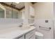 Clean bathroom featuring a vanity with decorative wallpaper, sink, toilet, and shower at 9730 W Gulf Hills Dr, Sun City, AZ 85351
