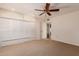 Bedroom with built in closets and storage with access to ensuite bathroom and neutral carpet at 9730 W Gulf Hills Dr, Sun City, AZ 85351