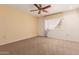 Bedroom with carpeted floors, neutral color palette, a ceiling fan and natural light from the window at 9730 W Gulf Hills Dr, Sun City, AZ 85351