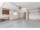 Spacious garage with ample room for parking and storage, including built-in shelving and work area at 9730 W Gulf Hills Dr, Sun City, AZ 85351