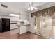 Bright kitchen featuring white cabinets, wood floors, and access to a private outdoor patio at 9730 W Gulf Hills Dr, Sun City, AZ 85351