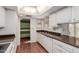 A well-lit kitchen features a sink and dishwasher with wood look flooring and ample counter space at 9730 W Gulf Hills Dr, Sun City, AZ 85351