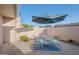 Outdoor patio with seating, shade umbrella, and tiled surface at 1005 W Berridge Ln, Phoenix, AZ 85013