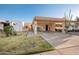 Inviting single-story home featuring a covered carport, well-maintained landscaping, and a charming gated courtyard at 1005 W Berridge Ln, Phoenix, AZ 85013