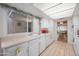 Bright kitchen with ample counter space, white cabinets, and a view into the adjacent dining and living areas at 1005 W Berridge Ln, Phoenix, AZ 85013