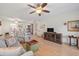 Open floorplan with a ceiling fan and hardwood floors connecting the living room to the kitchen at 1005 W Berridge Ln, Phoenix, AZ 85013