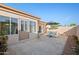 Enclosed patio area featuring a small table and chair set with an umbrella, creating an inviting outdoor space at 1005 W Berridge Ln, Phoenix, AZ 85013