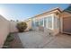 Enclosed patio area with concrete flooring, a small table, and view of the neutral-colored house exterior at 1005 W Berridge Ln, Phoenix, AZ 85013