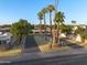 The street view showcases a tranquil setting with palm trees lining the roadway, enhancing its aesthetic appeal at 1005 W Berridge Ln, Phoenix, AZ 85013