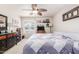 This bright bedroom has a ceiling fan, a bed, and dresser at 10510 W Palmeras Dr, Sun City, AZ 85373