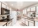 Functional kitchen with white appliances, ample counter space, and a cozy breakfast nook at 10510 W Palmeras Dr, Sun City, AZ 85373