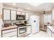 Well-lit kitchen equipped with modern appliances and white cabinets, perfect for cooking at 10510 W Palmeras Dr, Sun City, AZ 85373