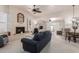 Spacious living room showcases a fireplace, inviting seating, and seamless flow to dining area at 10510 W Palmeras Dr, Sun City, AZ 85373