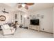 Spacious living room featuring a fireplace, carpeted floors, and ceiling fans at 10510 W Palmeras Dr, Sun City, AZ 85373