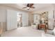 Bright and airy living room with sliding glass doors to an outdoor patio, a recliner, and carpeted floors at 10510 W Palmeras Dr, Sun City, AZ 85373