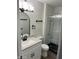 Remodeled bathroom featuring a walk-in shower with a glass enclosure and updated fixtures at 10924 W Santa Fe Dr, Sun City, AZ 85351