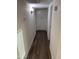 Hallway with modern flooring and convenient built-in storage cabinets at 10924 W Santa Fe Dr, Sun City, AZ 85351