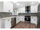 Modern kitchen featuring sleek white cabinets, stainless steel appliances, and a skylight at 10924 W Santa Fe Dr, Sun City, AZ 85351