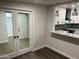 View of the updated kitchen through the pass-through window from living room with a view to second bedroom at 10924 W Santa Fe Dr, Sun City, AZ 85351