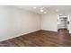 Bright living room boasting stylish flooring and an open layout to the kitchen at 10924 W Santa Fe Dr, Sun City, AZ 85351