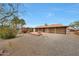 This large backyard features a screened in patio, desert landscaping and a charming fire pit at 11067 W White Mountain Rd, Sun City, AZ 85351