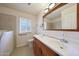 Well-lit bathroom featuring a double sink, walk-in tub, and ample counter space at 11067 W White Mountain Rd, Sun City, AZ 85351