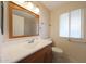 Bathroom with vanity, a large mirror, a shower over the tub, and natural light at 11067 W White Mountain Rd, Sun City, AZ 85351