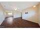 Bedroom with hardwood floors, large closet, ceiling fan, and a TV mount at 11067 W White Mountain Rd, Sun City, AZ 85351