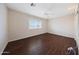 A bright bedroom features wood floors, a window and ceiling fan at 11067 W White Mountain Rd, Sun City, AZ 85351