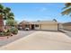 Single-story home featuring desert landscaping, a two-car garage, and a long concrete driveway at 11067 W White Mountain Rd, Sun City, AZ 85351