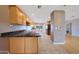 Well-lit kitchen featuring granite countertops, wooden cabinets, and stainless steel appliances at 11067 W White Mountain Rd, Sun City, AZ 85351