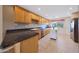 Modern kitchen with granite countertops, ample wooden cabinetry, and stainless steel appliances at 11067 W White Mountain Rd, Sun City, AZ 85351