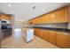 Bright, spacious kitchen featuring plentiful cabinets, a center island, and modern appliances at 11067 W White Mountain Rd, Sun City, AZ 85351