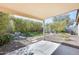 Covered patio with beautifully landscaped backyard featuring rock features, bamboo, and manicured greenery at 11229 E Emelita Ave, Mesa, AZ 85208