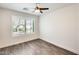 This bedroom features a ceiling fan, neutral colors, and a window with shutters at 11229 E Emelita Ave, Mesa, AZ 85208