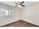 This bedroom features a ceiling fan, neutral colors, and a window with shutters at 11229 E Emelita Ave, Mesa, AZ 85208