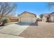 Single-story home with a two-car garage and low maintenance desert landscaping at 11229 E Emelita Ave, Mesa, AZ 85208