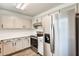 Bright kitchen with stainless steel appliances, shaker cabinets and quartz countertops at 11229 E Emelita Ave, Mesa, AZ 85208