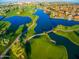 Aerial view of the community featuring lush green golf course and blue water features at 1152 W Sunrise Pl, Chandler, AZ 85248