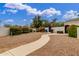 Fenced backyard with a paved walkway, blooming bushes, and a basketball hoop, offering privacy and recreation at 1152 W Sunrise Pl, Chandler, AZ 85248