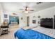 Bedroom with an oversized mirror closet, neutral carpeting, fan lighting, and decorative sports memorabilia at 1152 W Sunrise Pl, Chandler, AZ 85248