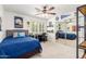 Bedroom with a large mirror closet, natural lighting, fan lighting, and a comfortable workspace at 1152 W Sunrise Pl, Chandler, AZ 85248