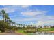 Scenic view of the lush green golf course with palm trees and water features under a blue sky at 1152 W Sunrise Pl, Chandler, AZ 85248