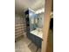 Bathroom with blue vanity and shelves, adding a pop of color and character to the space at 12132 W Daley Ln, Sun City, AZ 85373