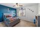 bedroom with racecar theme, neutral carpet, ceiling fan and ample natural light from window at 12132 W Daley Ln, Sun City, AZ 85373