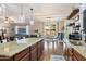 Open concept kitchen with island seating, hardwood floors, and lots of natural light at 12132 W Daley Ln, Sun City, AZ 85373